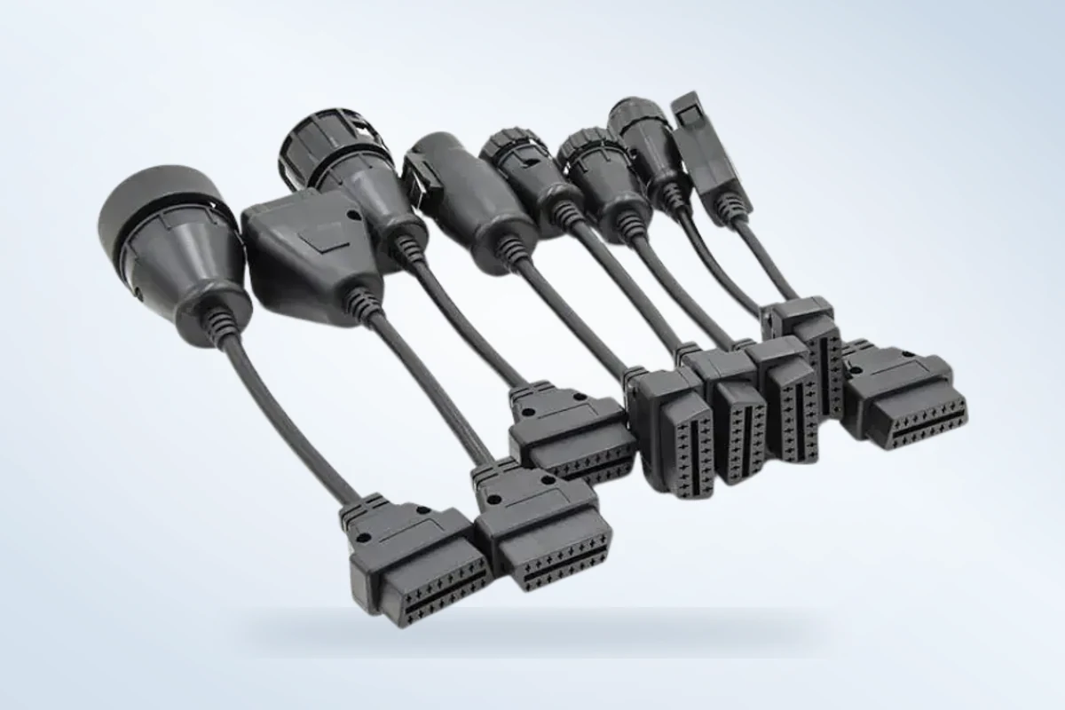 Vehicle and device side connection ends of heavy-duty vehicle adapters on a gray studio background