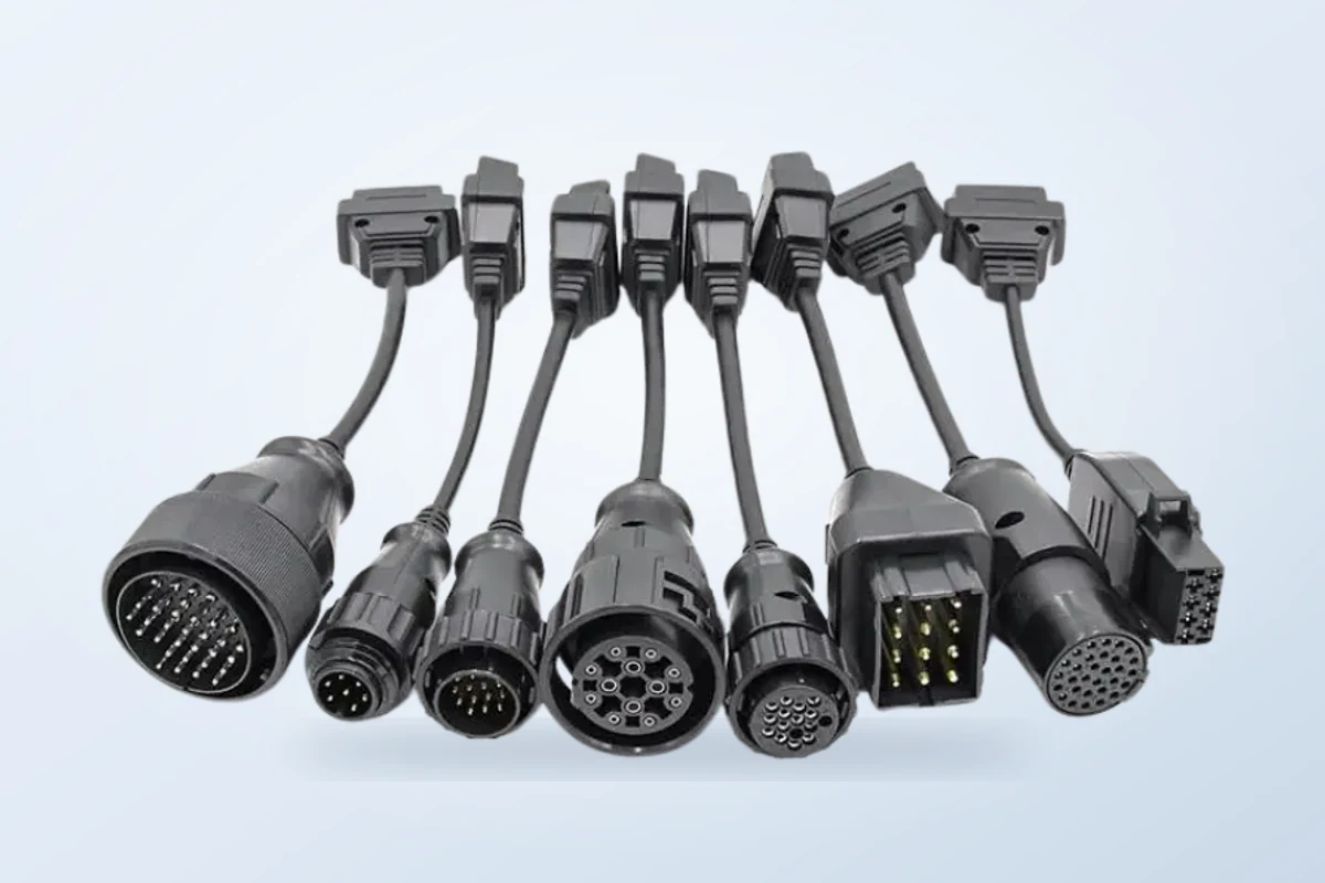 Connectors of the heavy-duty vehicle OBD adapter cable set on a gray studio background